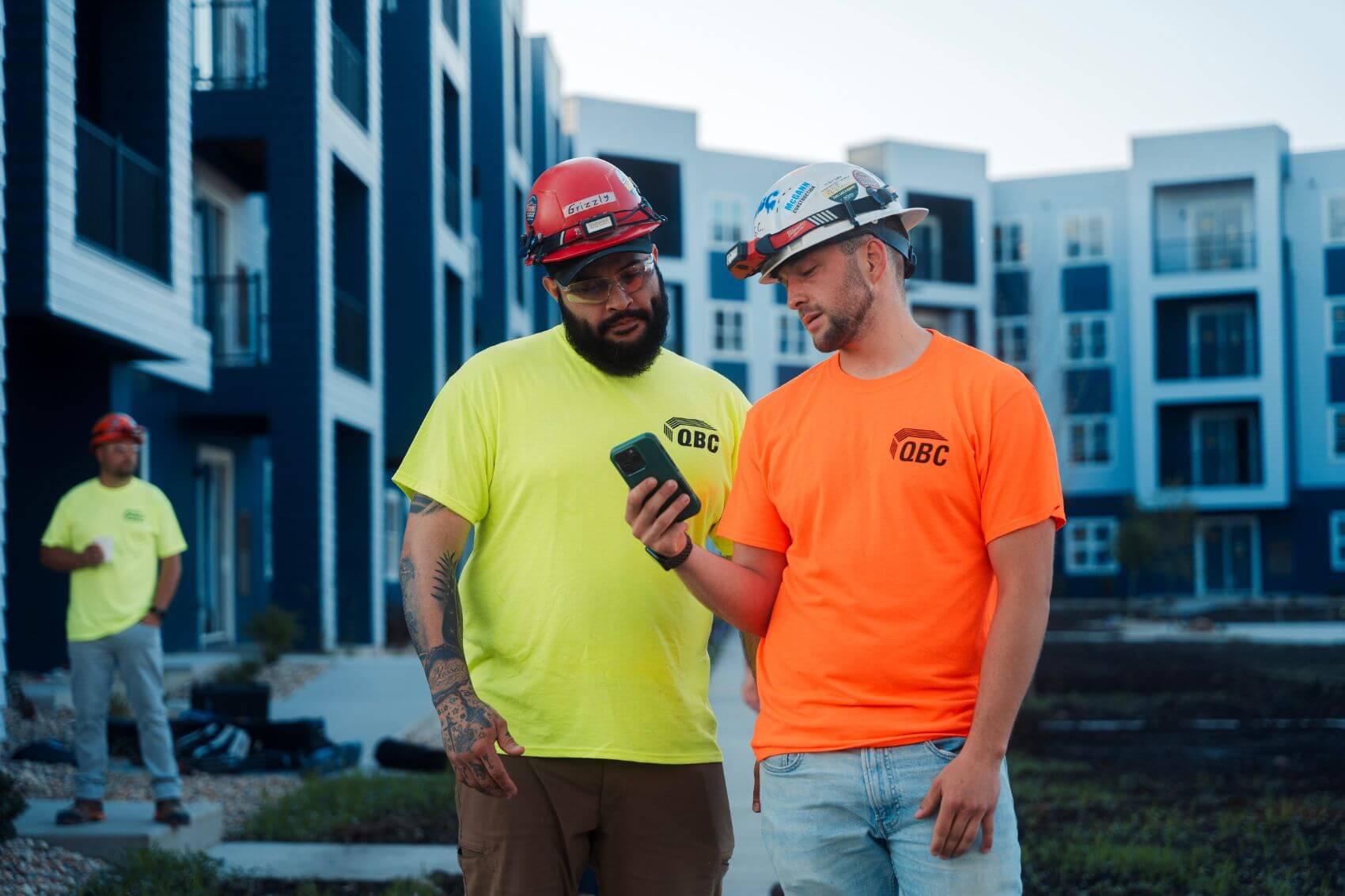 Two carpenters discussing punch at the Signature Pointe multifamily jobsite in Madison, Wisconsin.