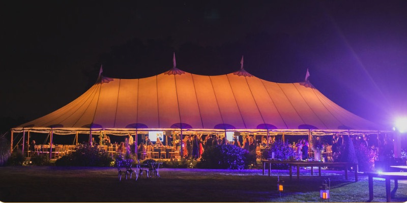A large event tent lit from within at night
