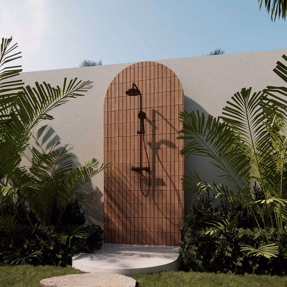 Terracotta tiled outdoor shower surrounded by lush greenery