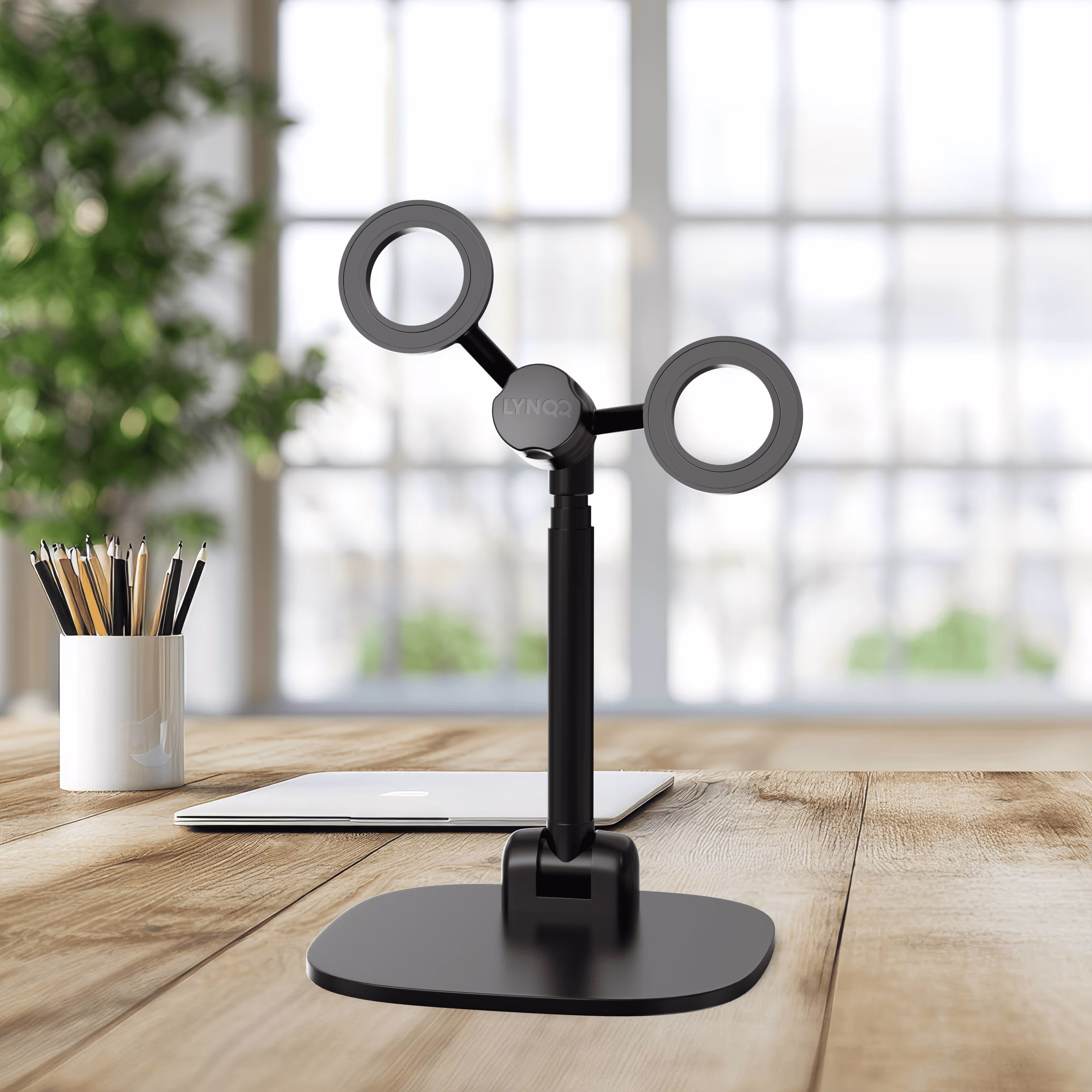 Adjustable black desk lamp with two circular lights near pencil holder
