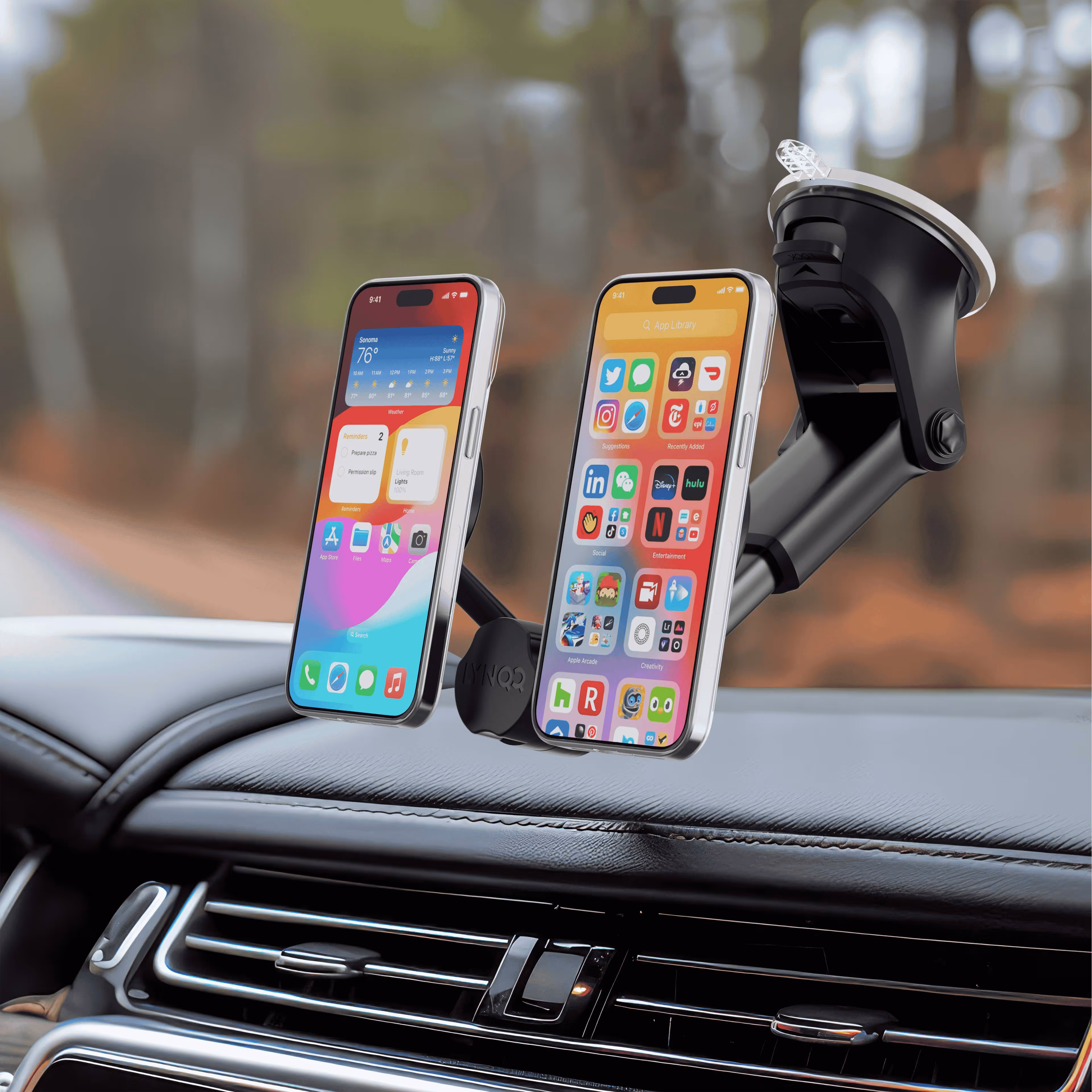 Two smartphones mounted on car dashboard using adjustable phone holder