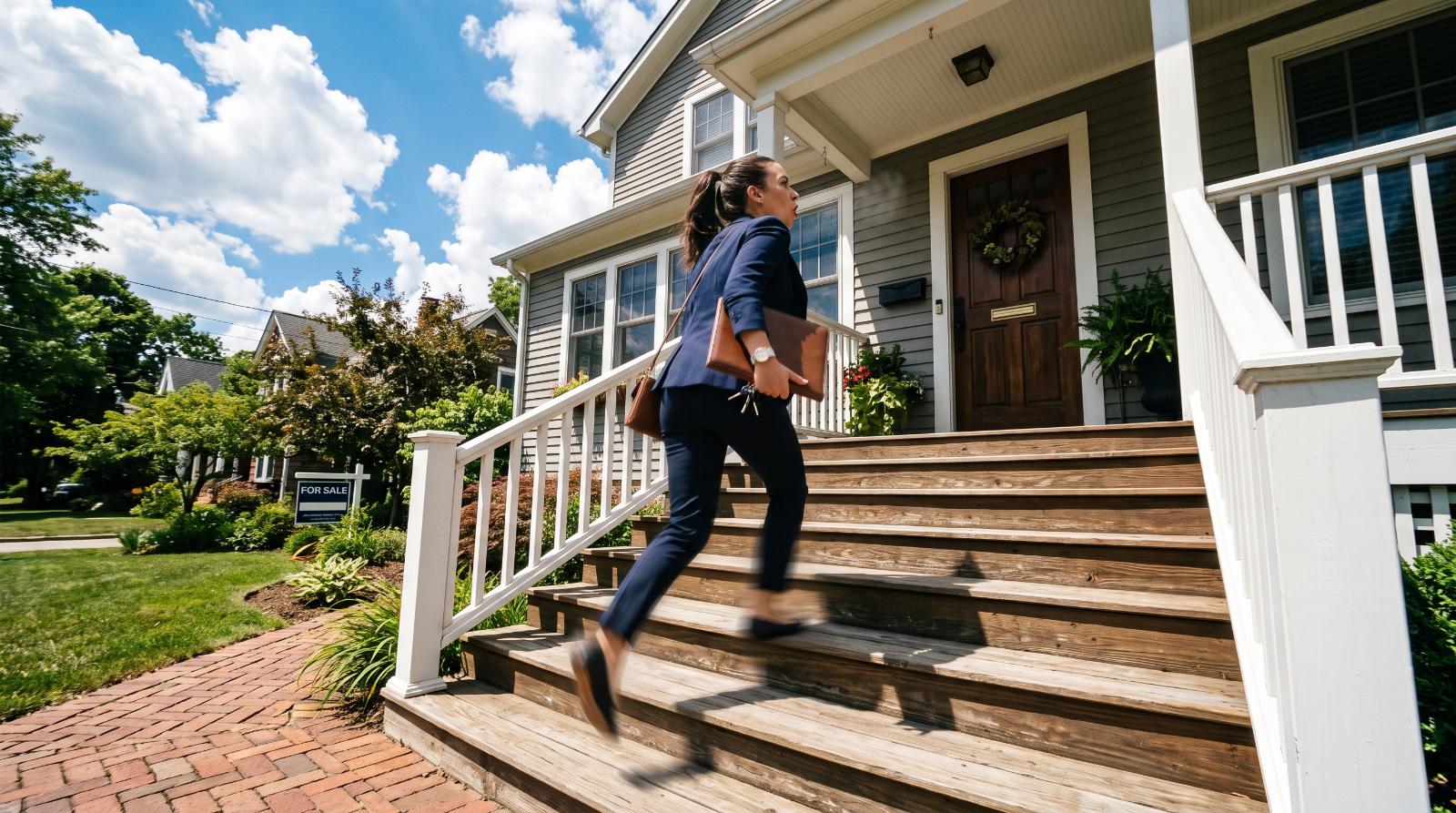 Agent hurrying up porch steps while juggling a busy solo workload