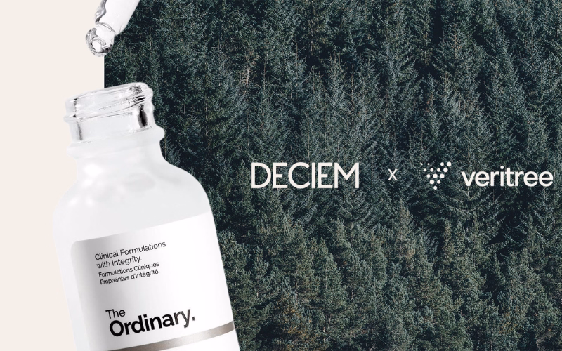 Cosmetics bottle by The Ordinary brand next to a forest landscape