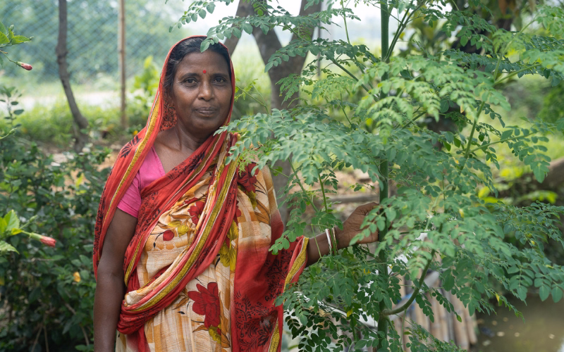 Kajol Mondal showcasing trees grown in her garden