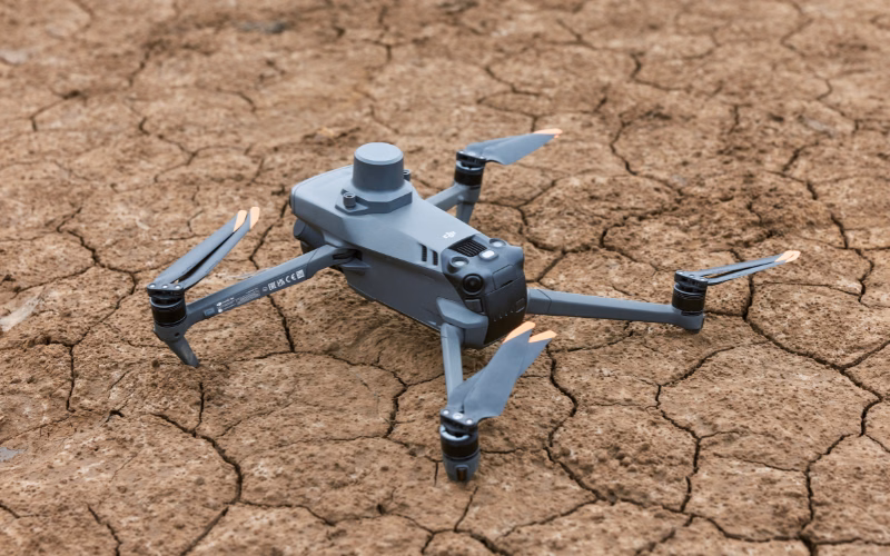 Drone resting on cracked dry soil at a restoration project site