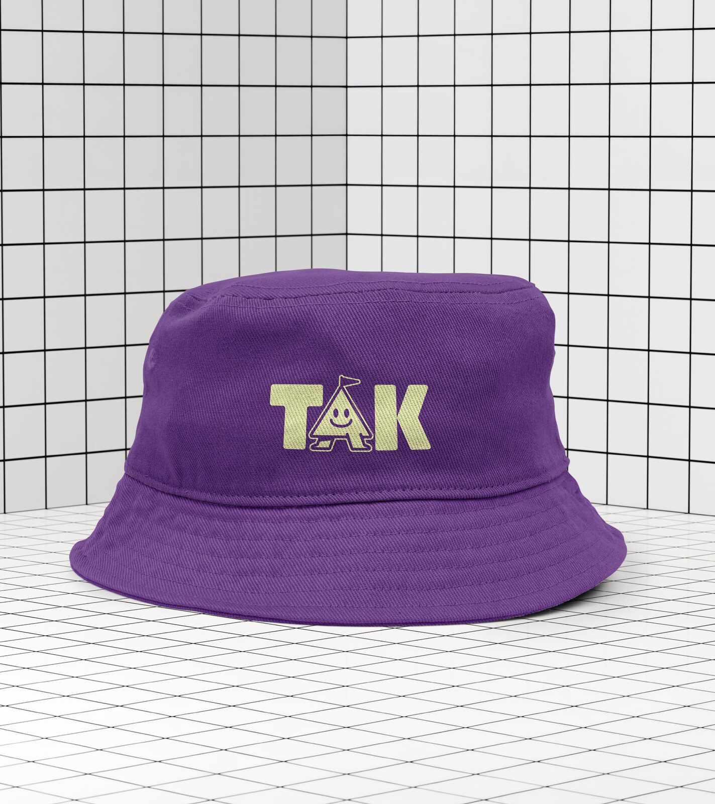 The Abode Kids bucket hat, purple with the TAK wordmark