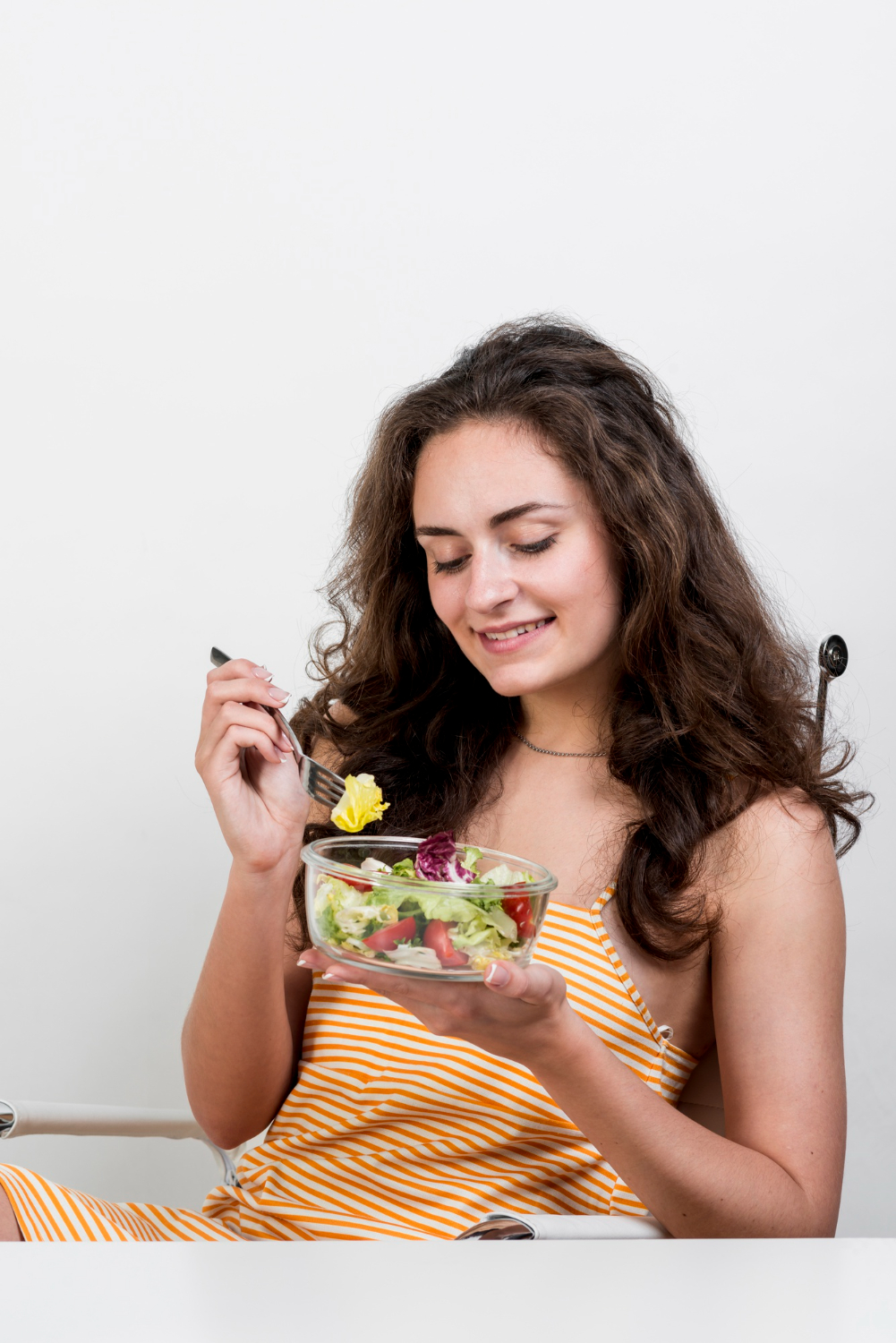 Woman enjoying a healthy carbohydrate-rich meal, illustrating smart carb choices for women over 40.
