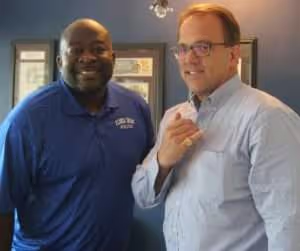 Attorney Chris Janes with Mr. Christopher Bell, Director and Head Coach of Florida Dreams. Attorney Chris Janes is wearing the North Florida Panhandle AAU Championship ring won by Coach Bell’s Florida Dream team.