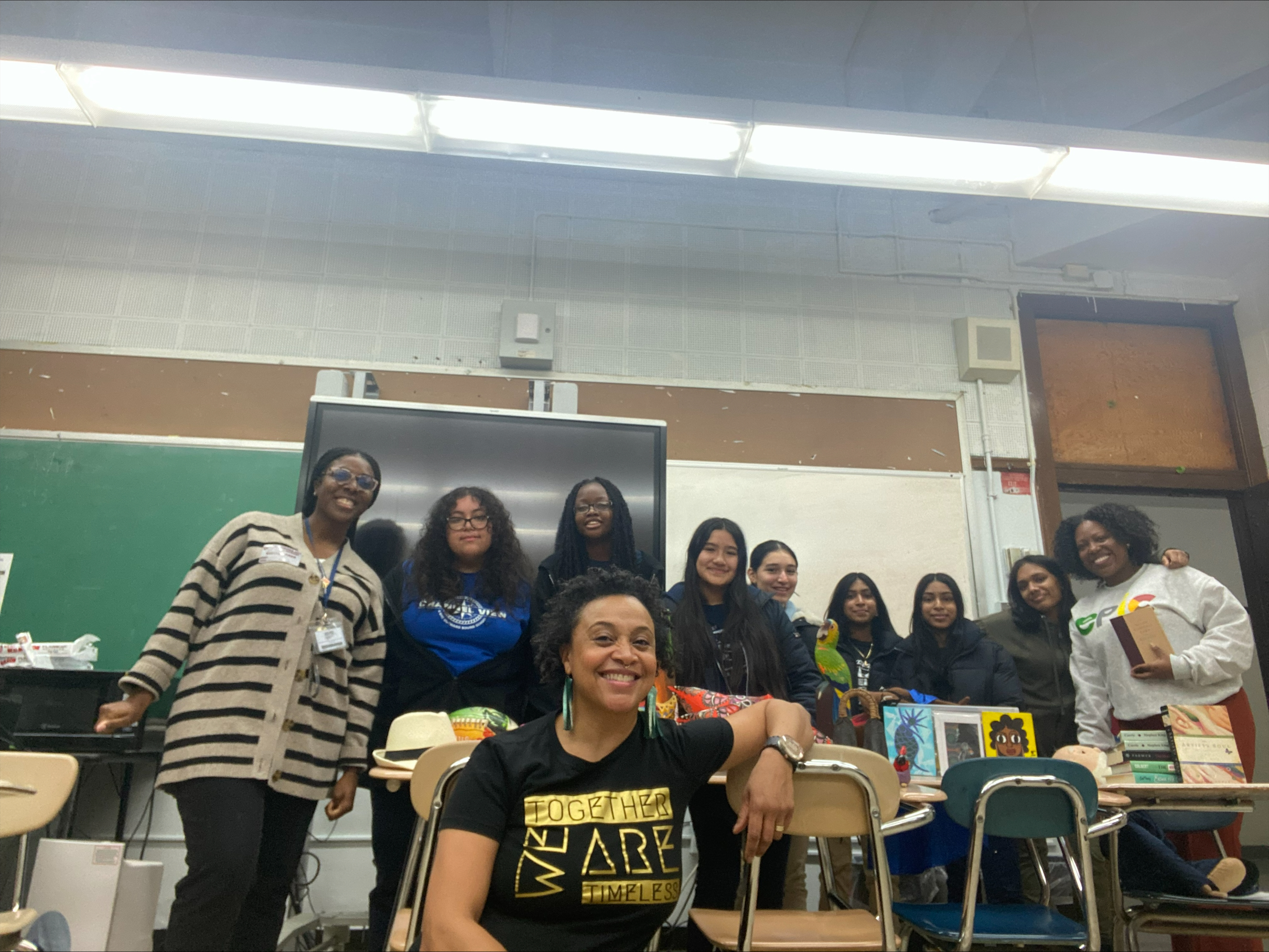 Students and staff pose together in a school classroom