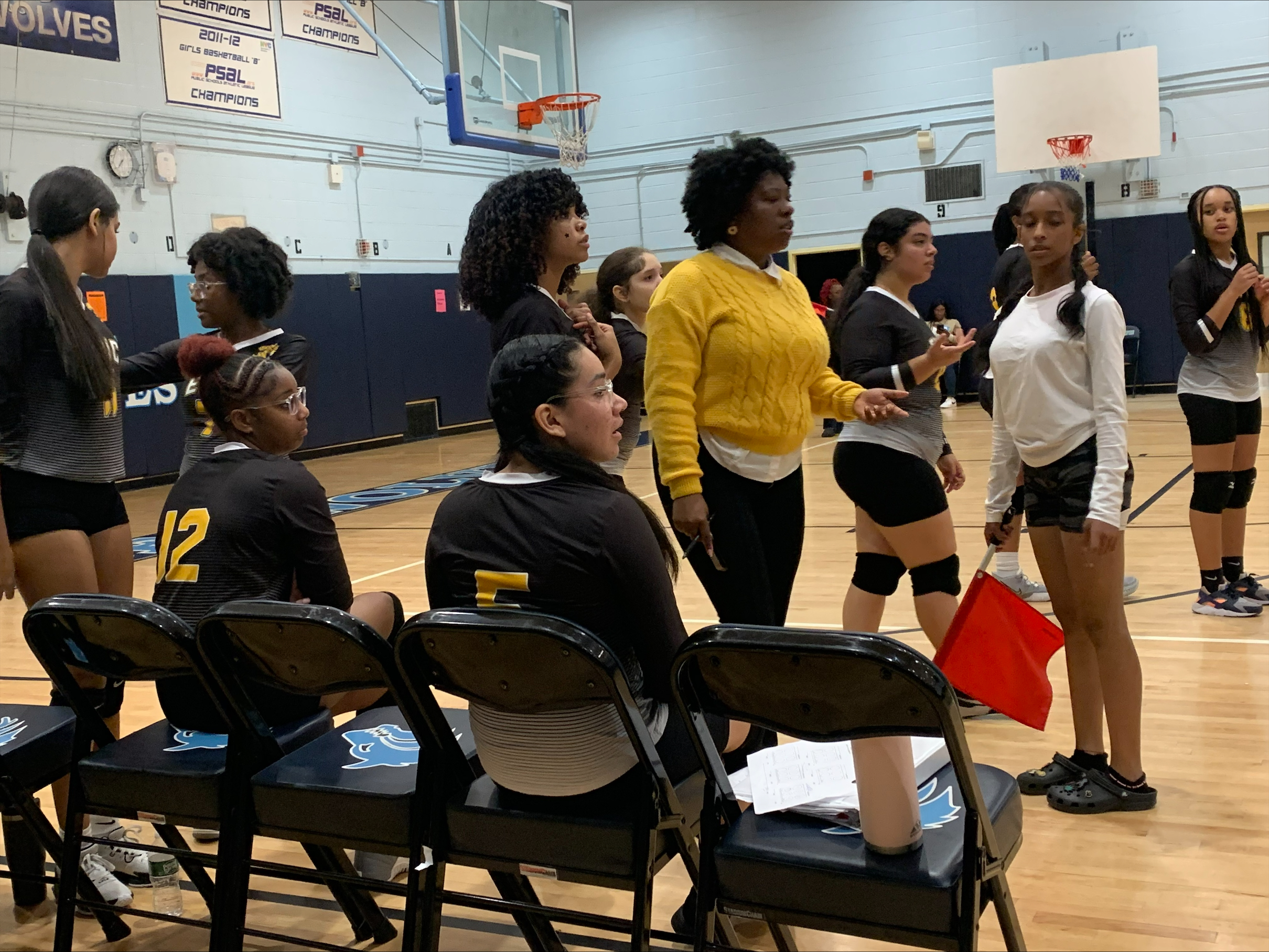 Girls volleyball team gathered on the court during a match