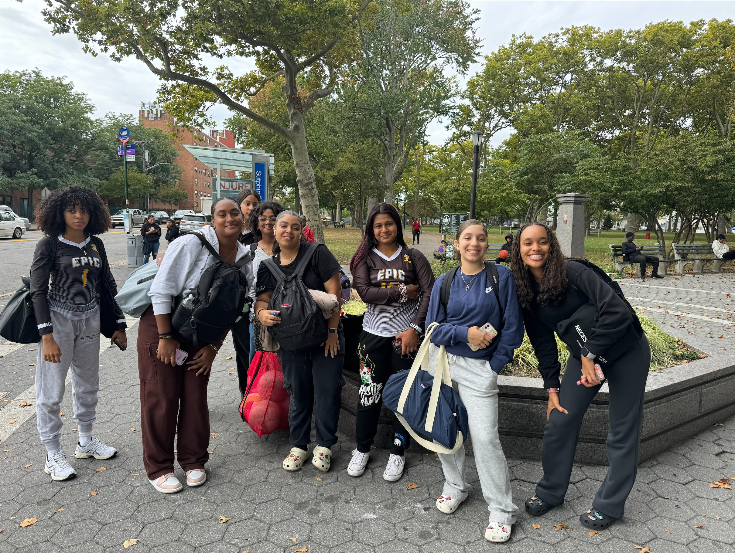 Students from EPIC High School posing outdoors on a college campus visit