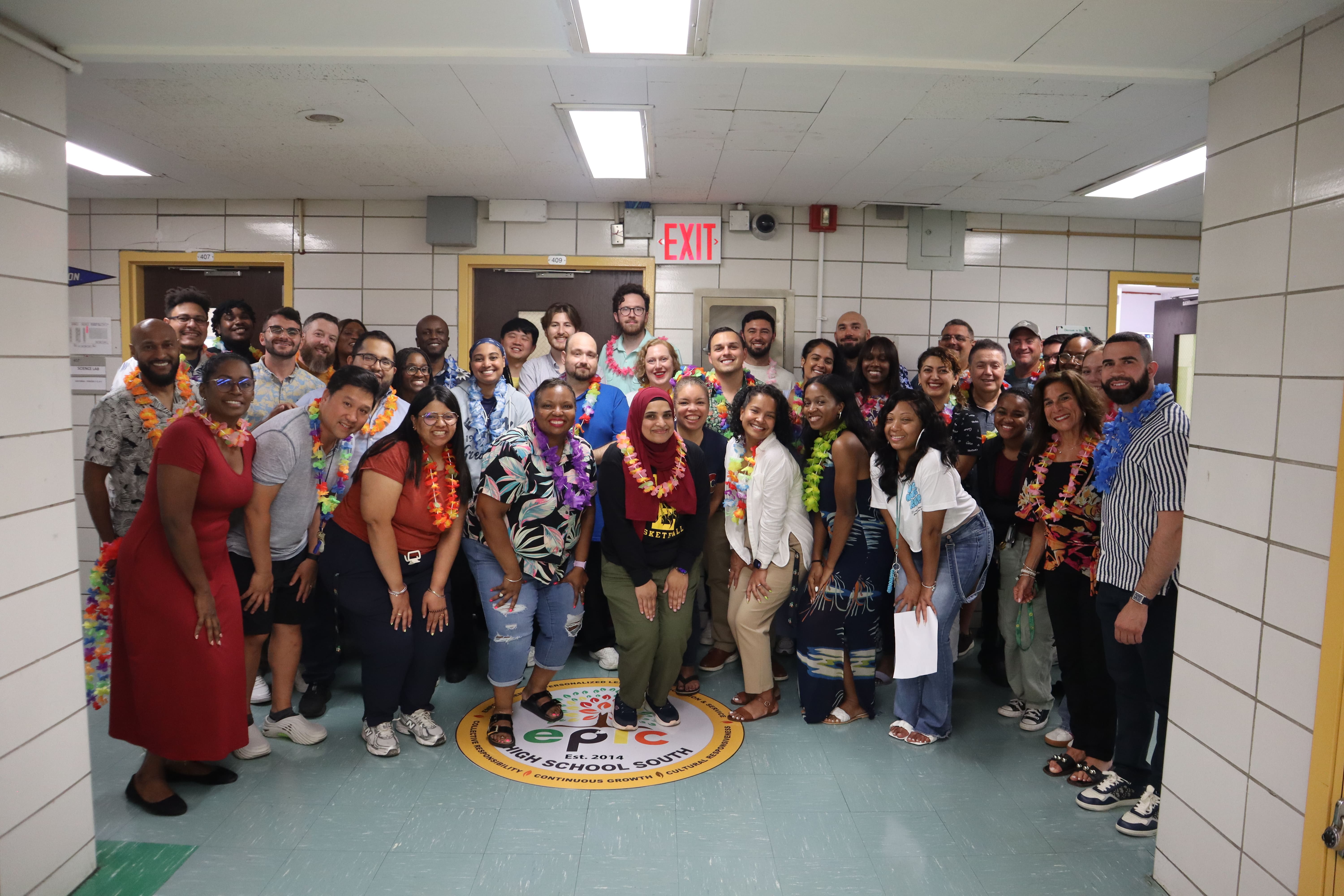 EPIC High School South staff posing together wearing colorful leis