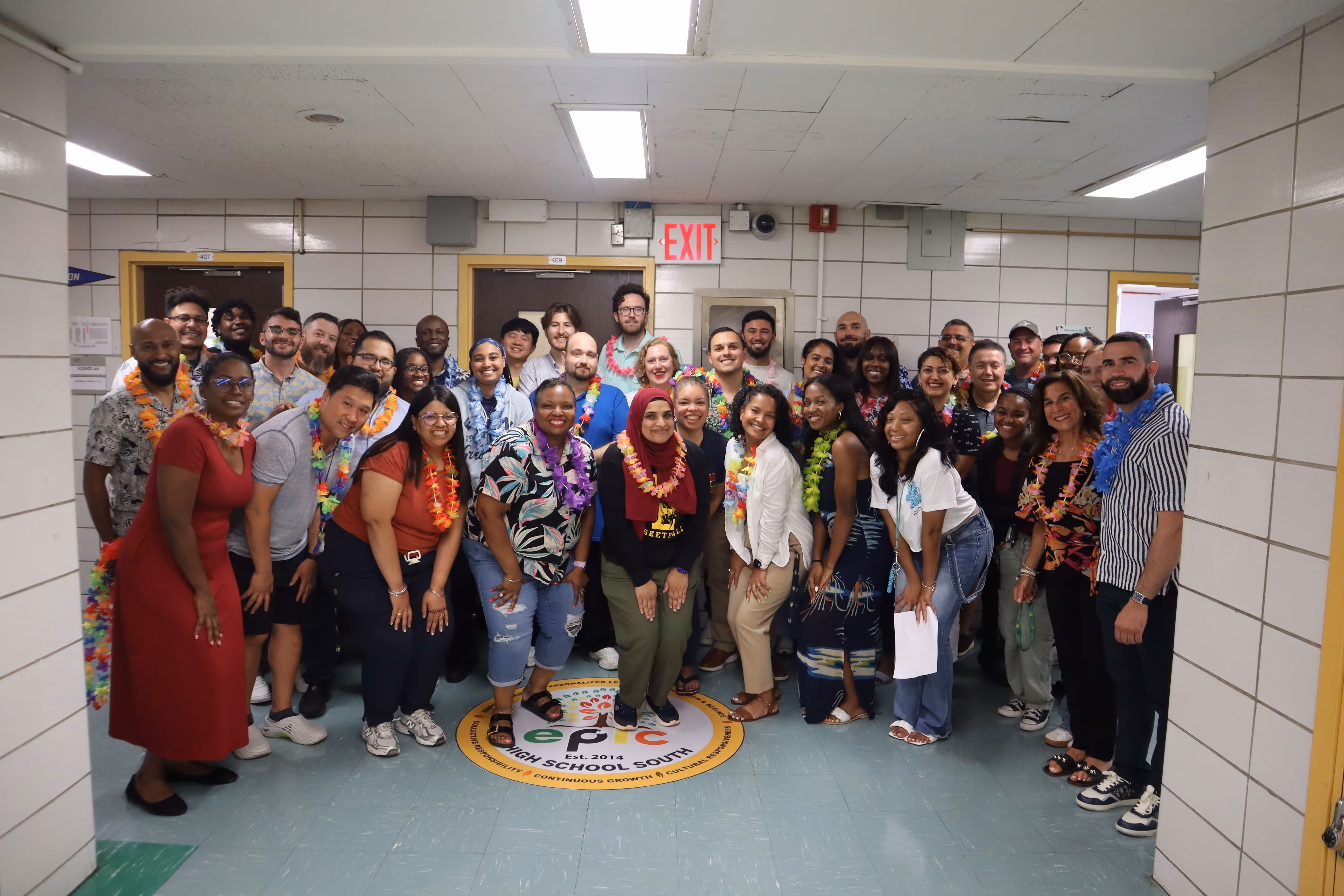 EPIC High School South staff posing together wearing colorful leis
