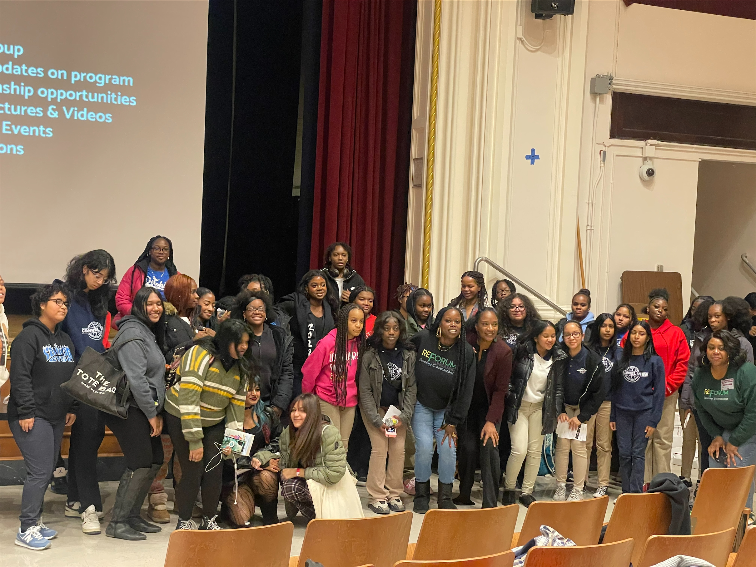 Students gather in school auditorium during a program assembly event
