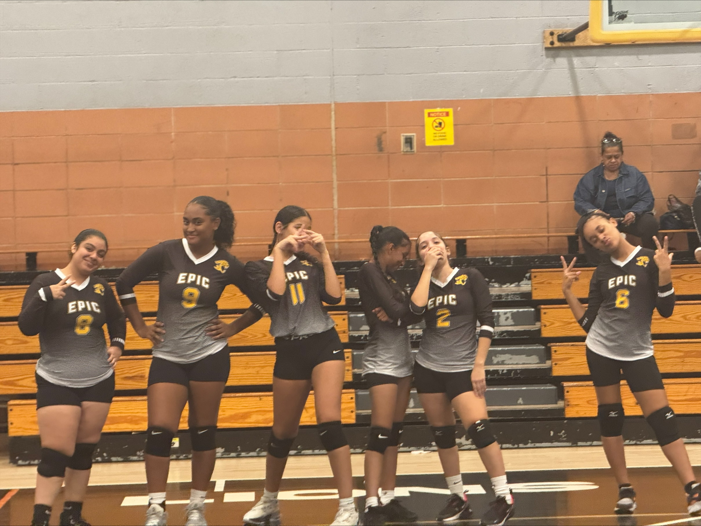 EPIC High School South volleyball players posing together in gym