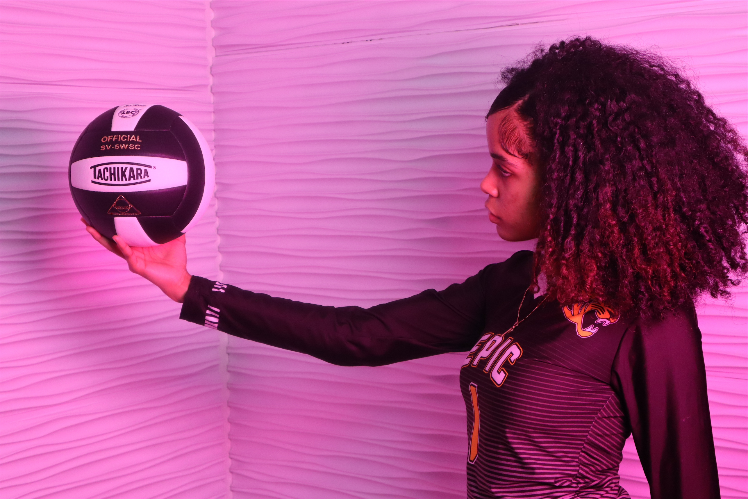 Epic High School South volleyball player holding a Tachikara ball