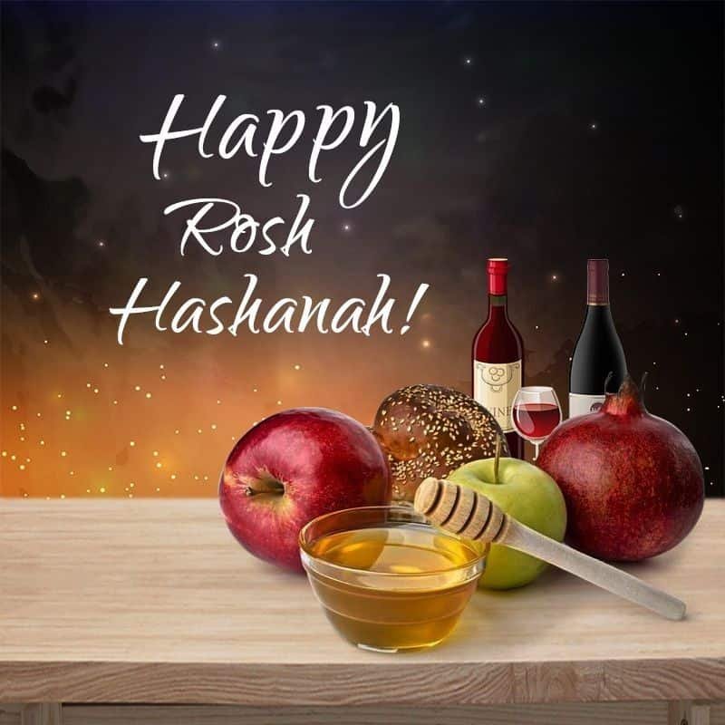 Happy Rosh Hashanah greeting with apples honey challah and pomegranate
