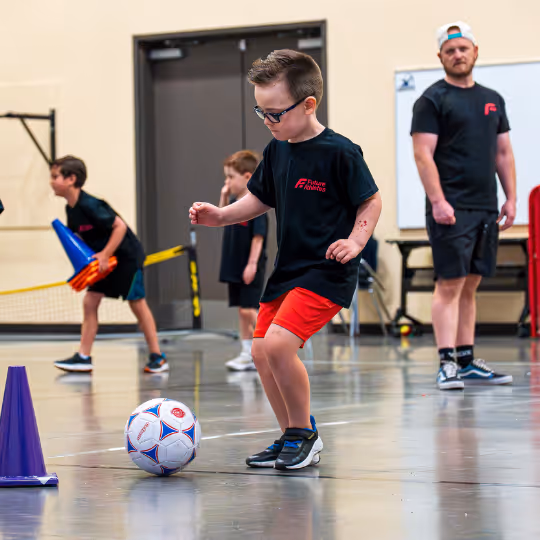 Kid about to kick soccer ball