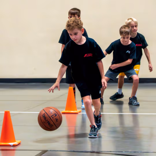 Kid practicing basketball