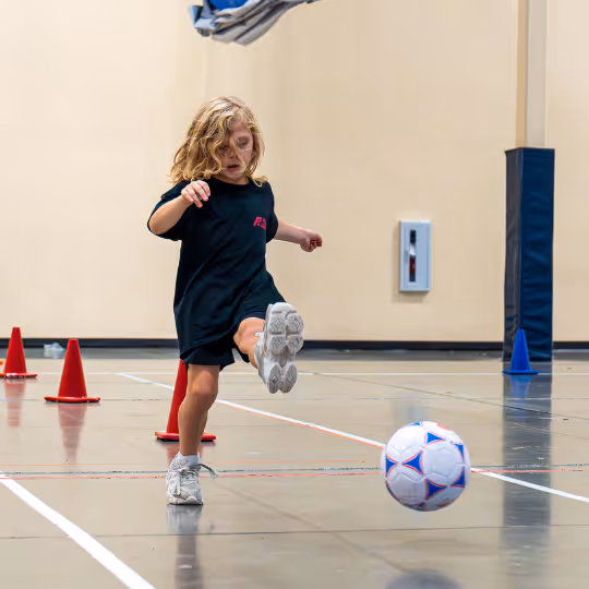 Kid kicking a soccer ball