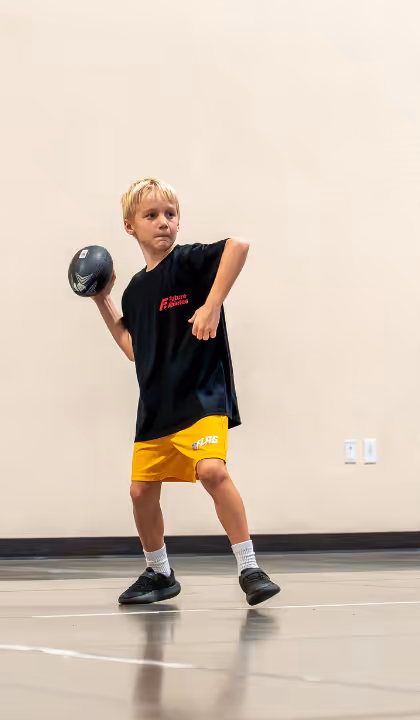 Kid throwing a football