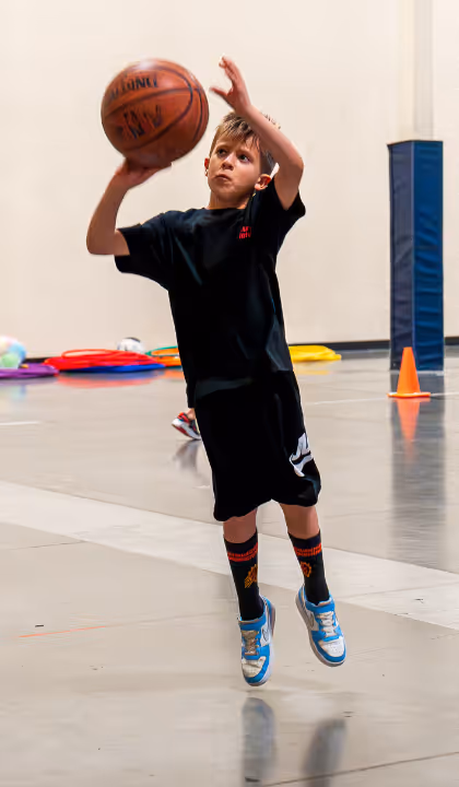 Kid shooting a basketball