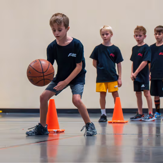 Kid learning to dribble