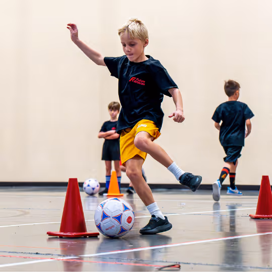 Kid kicking soccer ball
