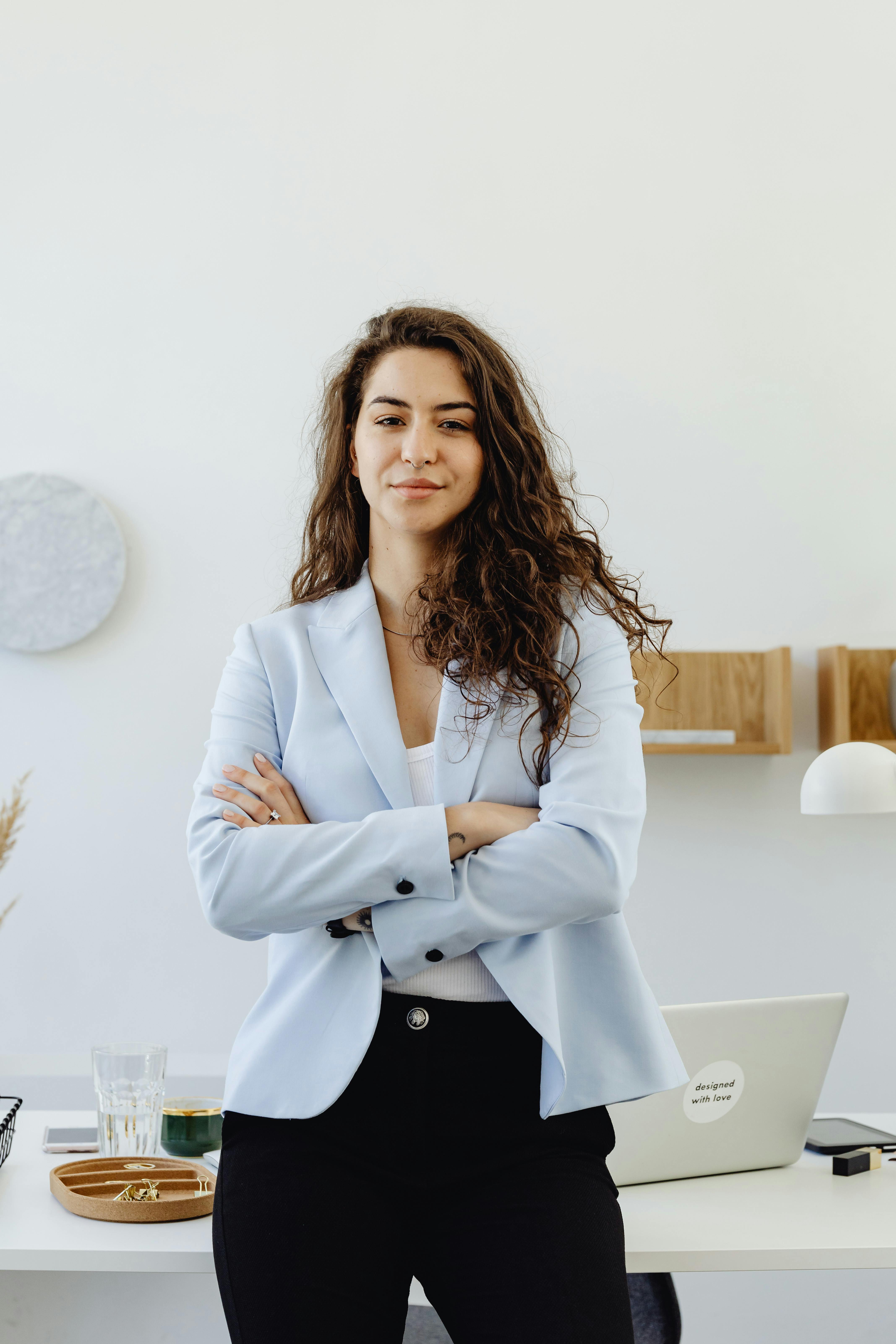 Female finance business owner standing with arms crossed