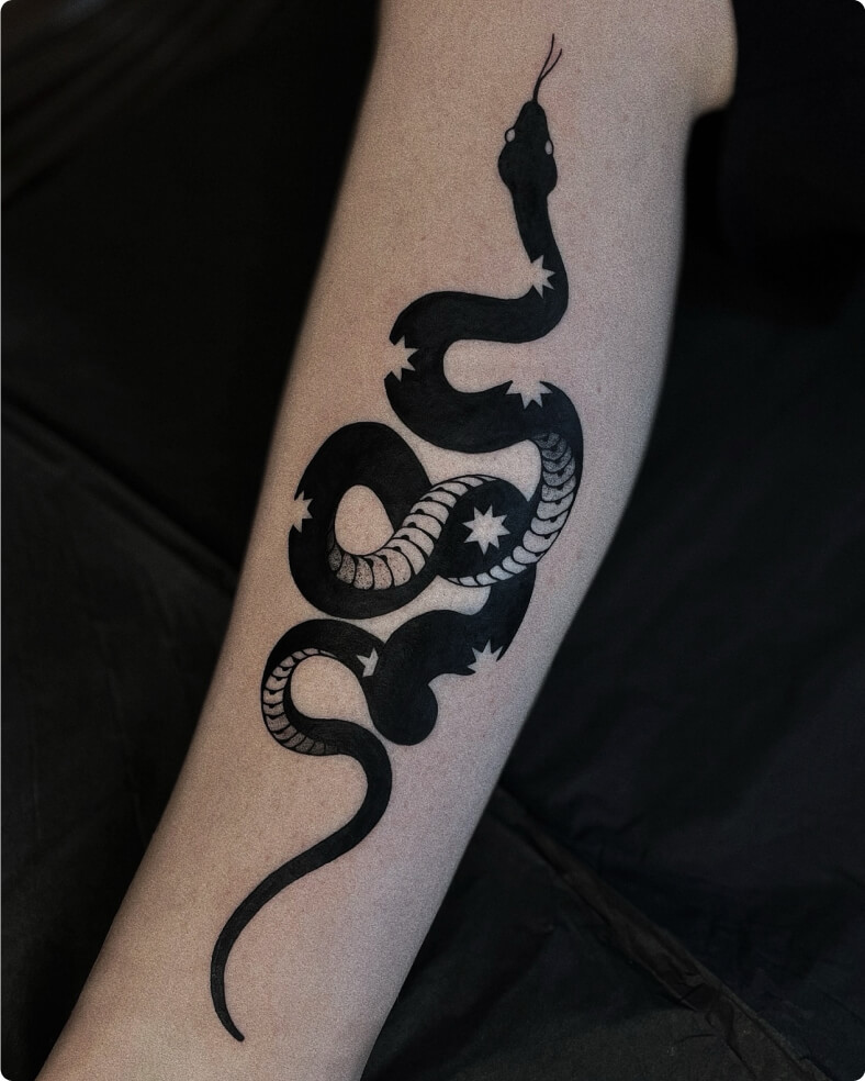 Tattoo of a black snake with star pattern on calf