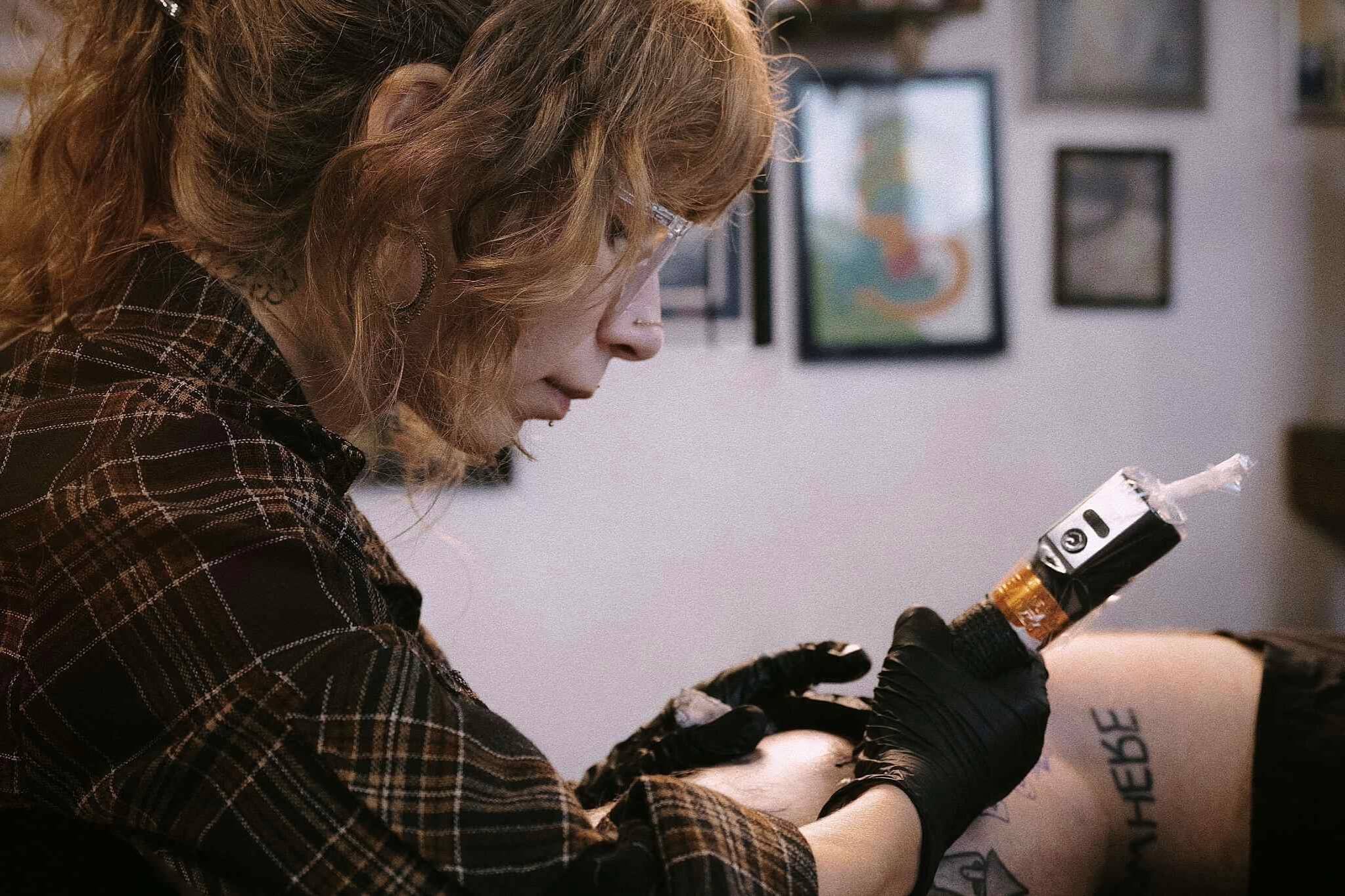 Tattoo artist preforming a tattoo