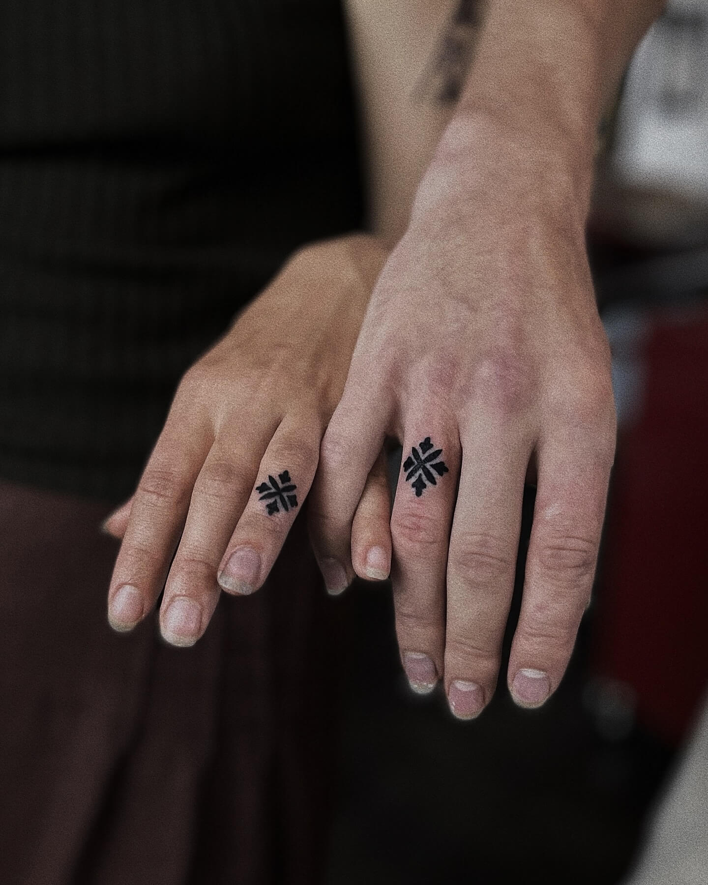 Couple wedding band tattoo on fingers
