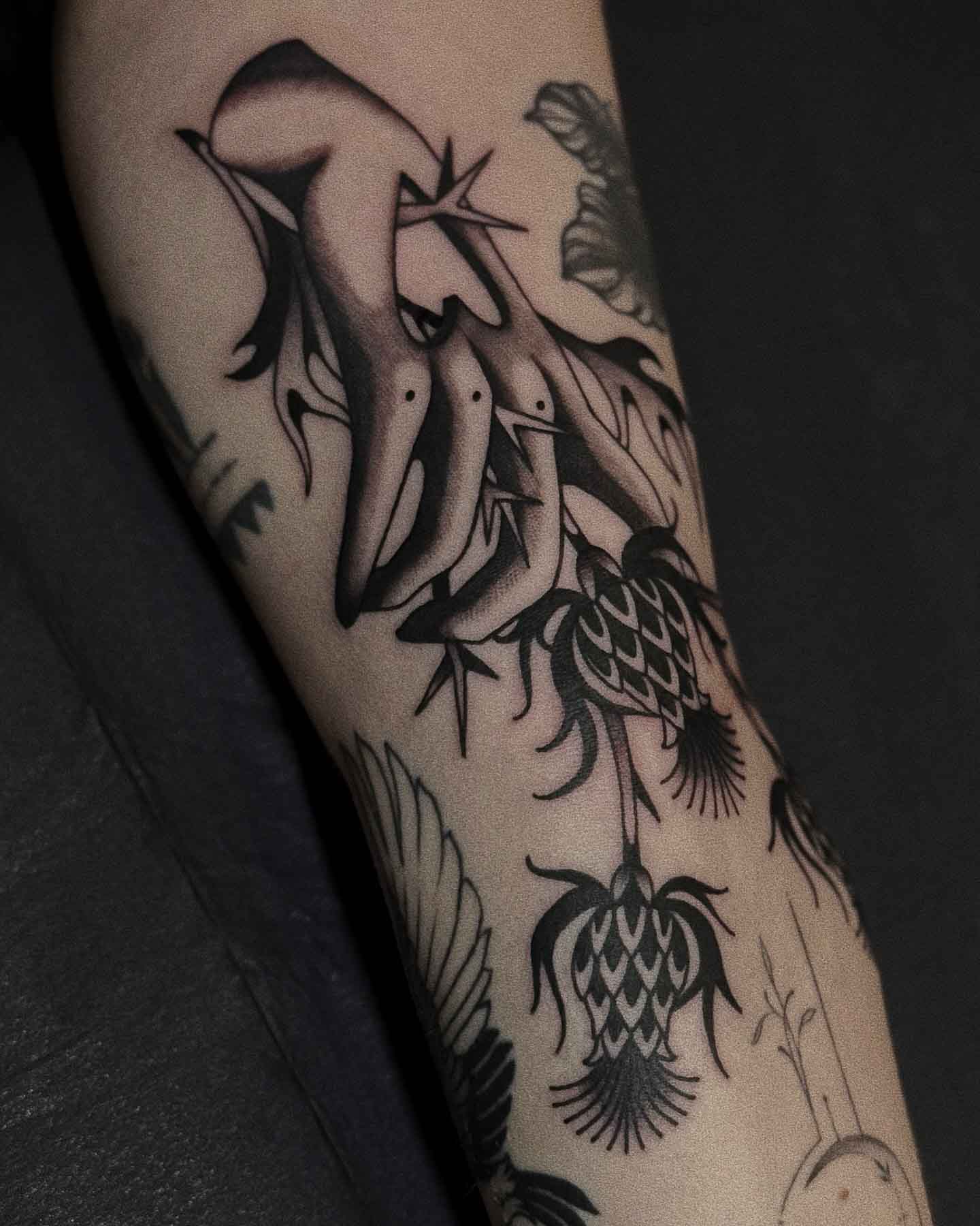 Tattoo of hand with thistle branch