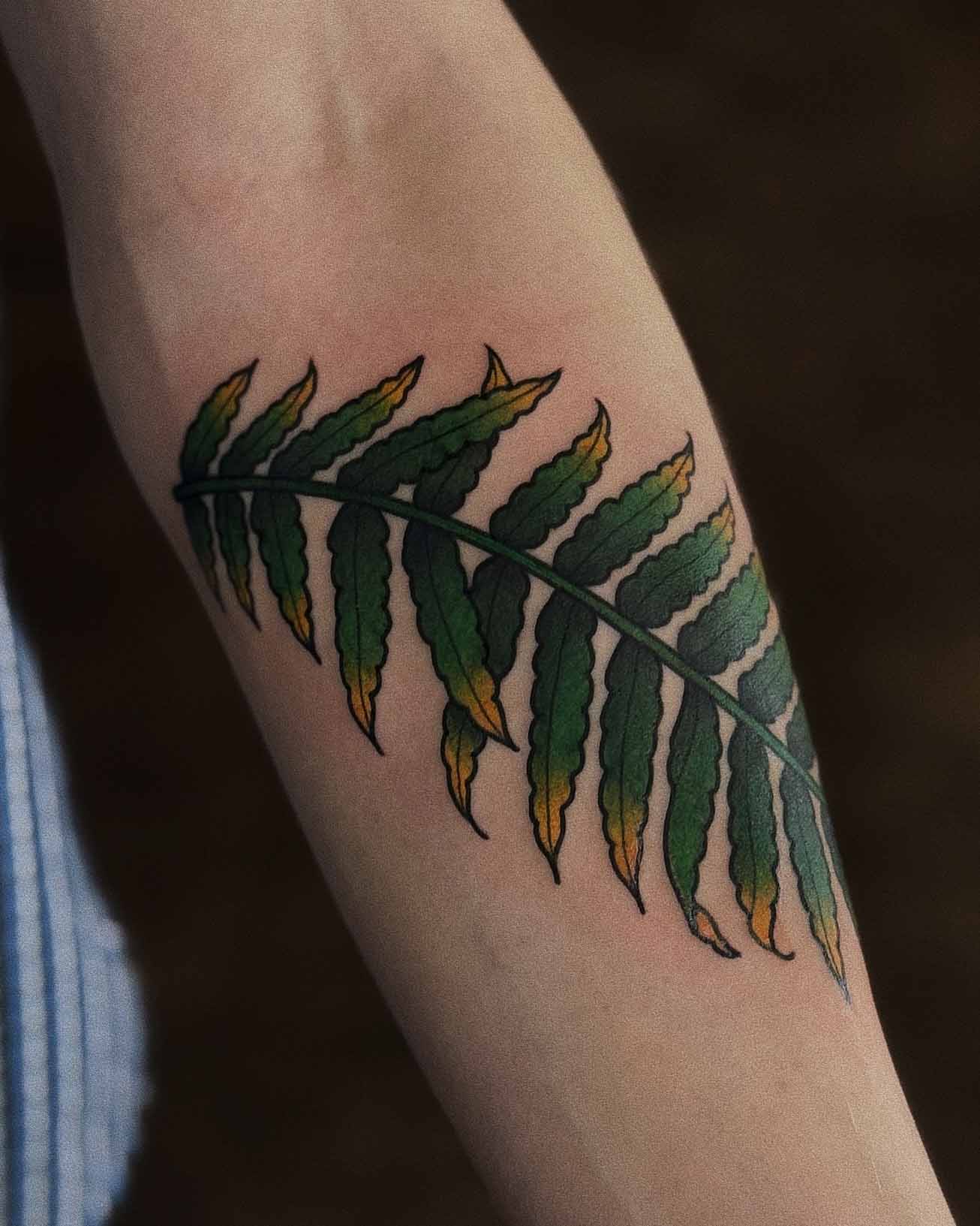 Colourful traditional palm tree leaf tattoo