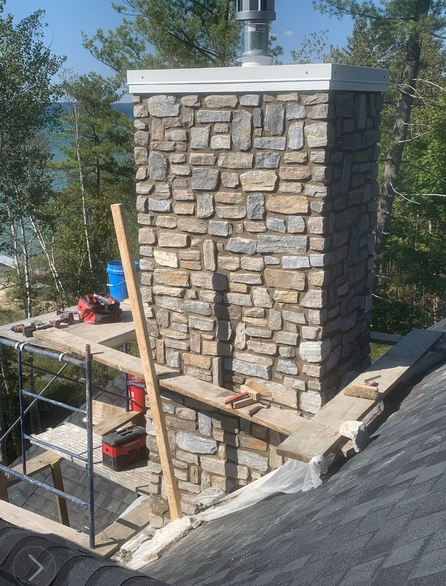 Veneer stone chimney and cap
