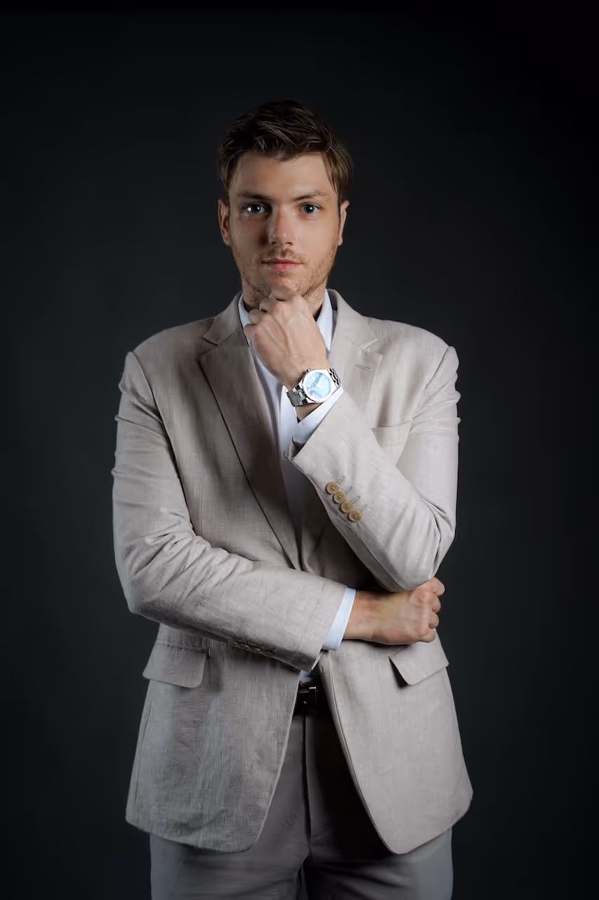 Full-body portrait of Julien Gadea, CEO of SalesMind AI, in a professional suit pose.