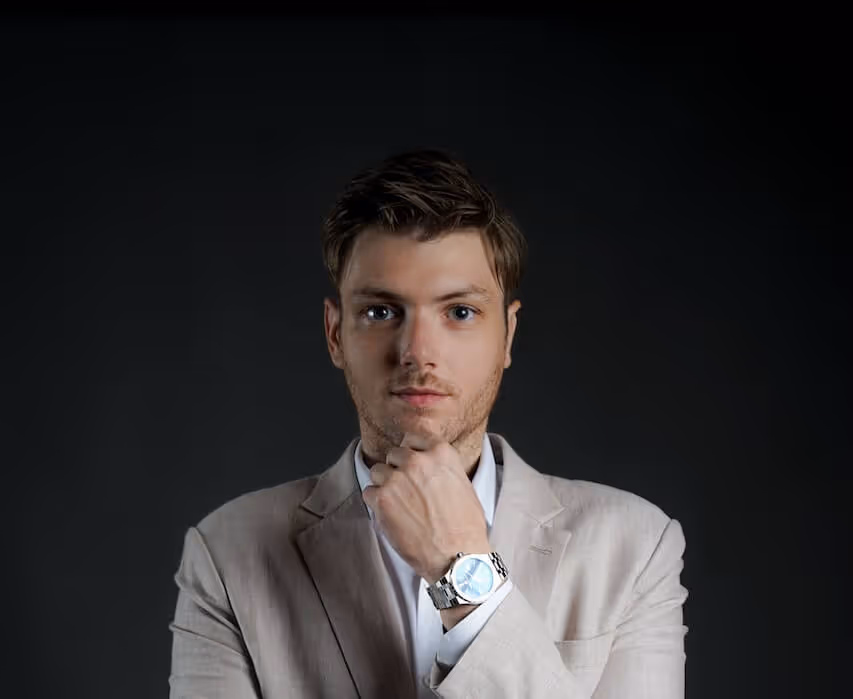 Professional headshot of Julien Gadea, CEO of SalesMind AI, with hand on chin.