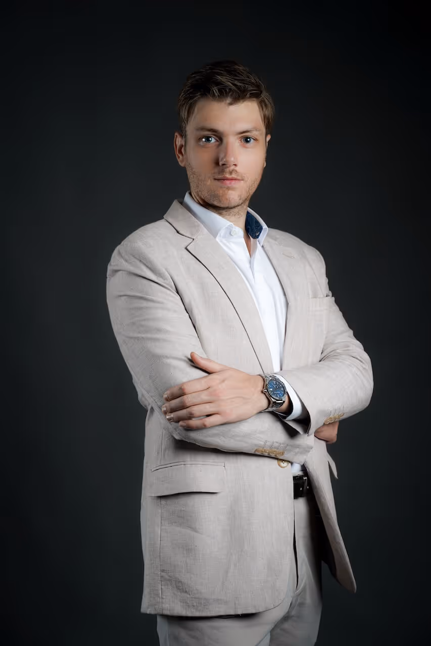 Full-body portrait of Julien Gadea, CEO of SalesMind AI, with arms crossed.