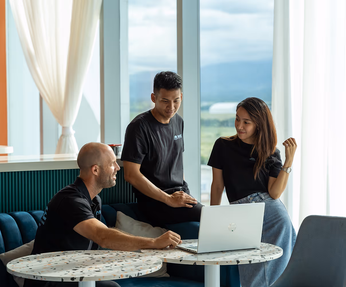 BASE global team sitting by a window in a team meeting