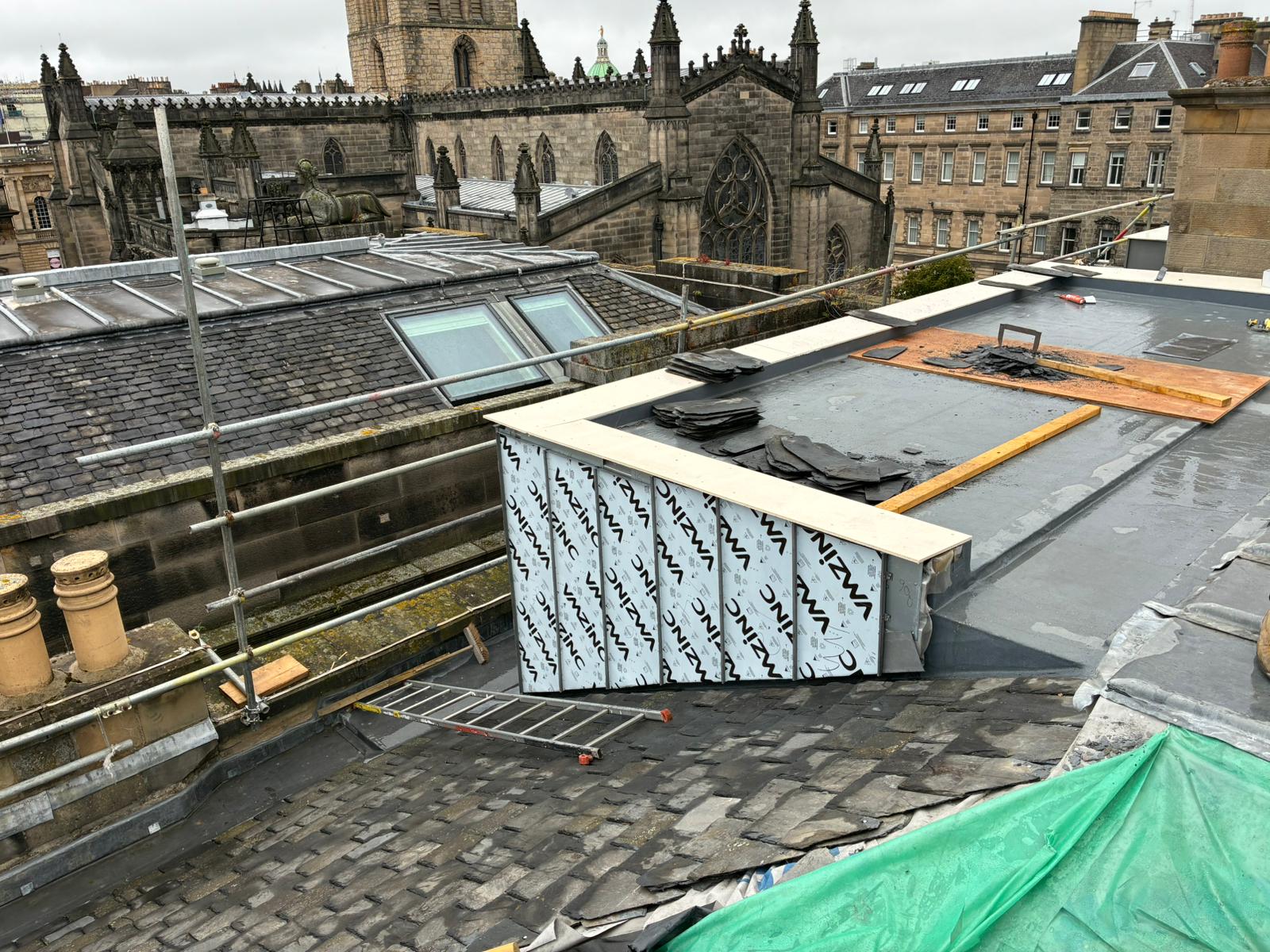 Rooftop view during slate strip and re-roofing works at 1A Parliament Square, Edinburgh, with new VM Zinc Quartz Plus dormer cladding visible