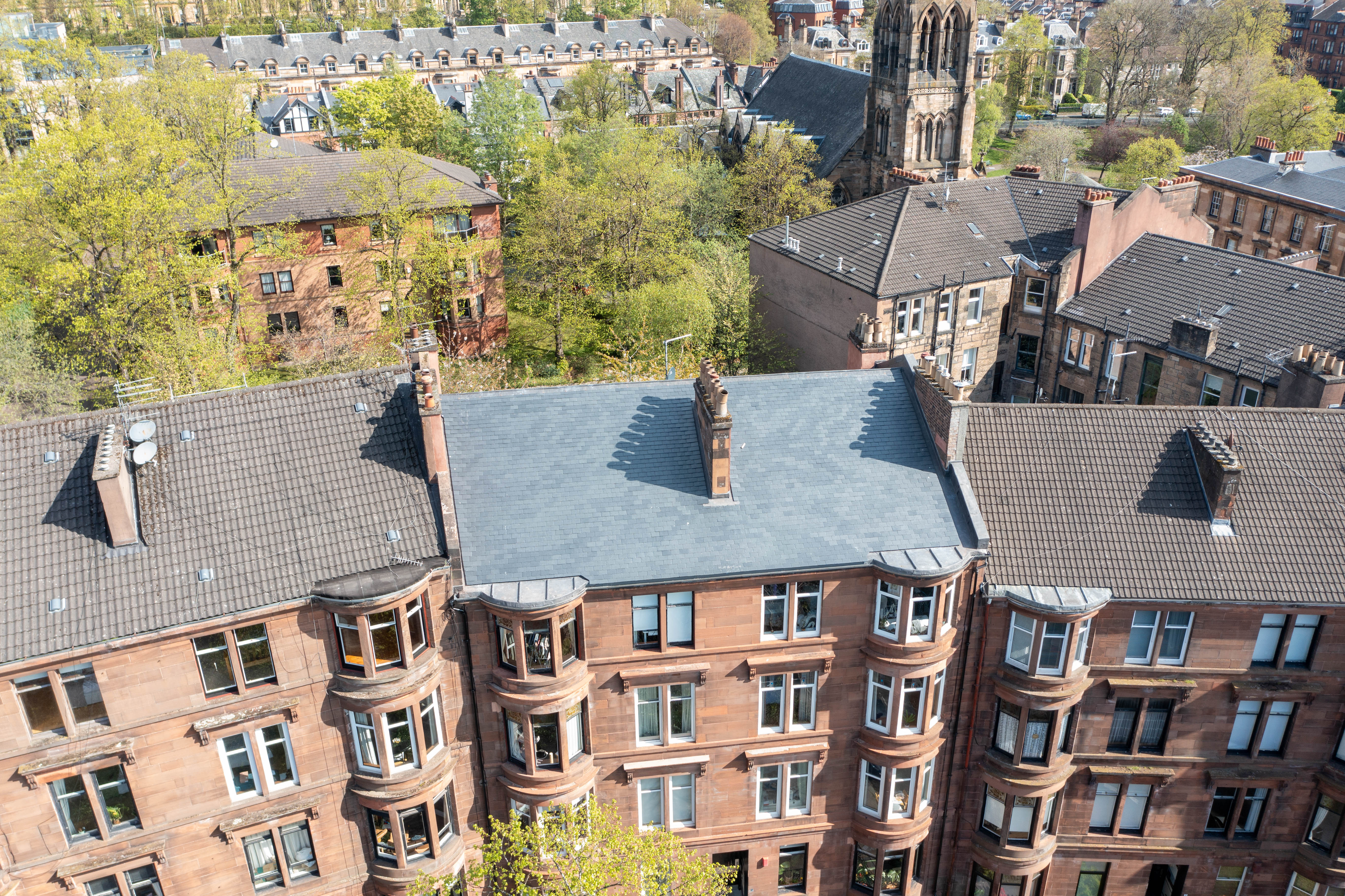 Roofing Advisors - Completed re-roofing and stonework restoration on a red sandstone tenement on Caird Drive, Glasgow West End