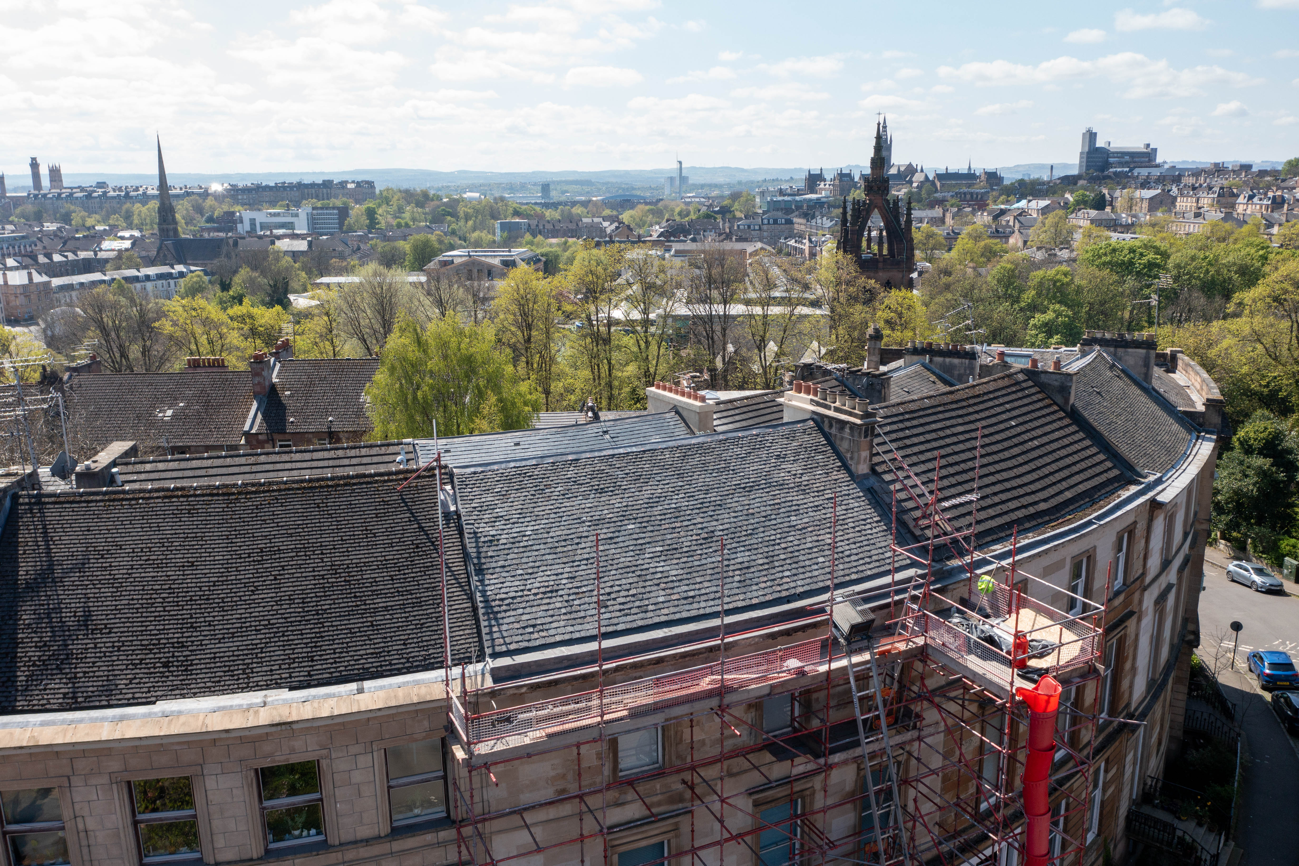 Completed heritage tenement re-roofing on Wilton Street, Glasgow, showing CUPA H3 slate, cast iron rainwater goods and restored roofscape