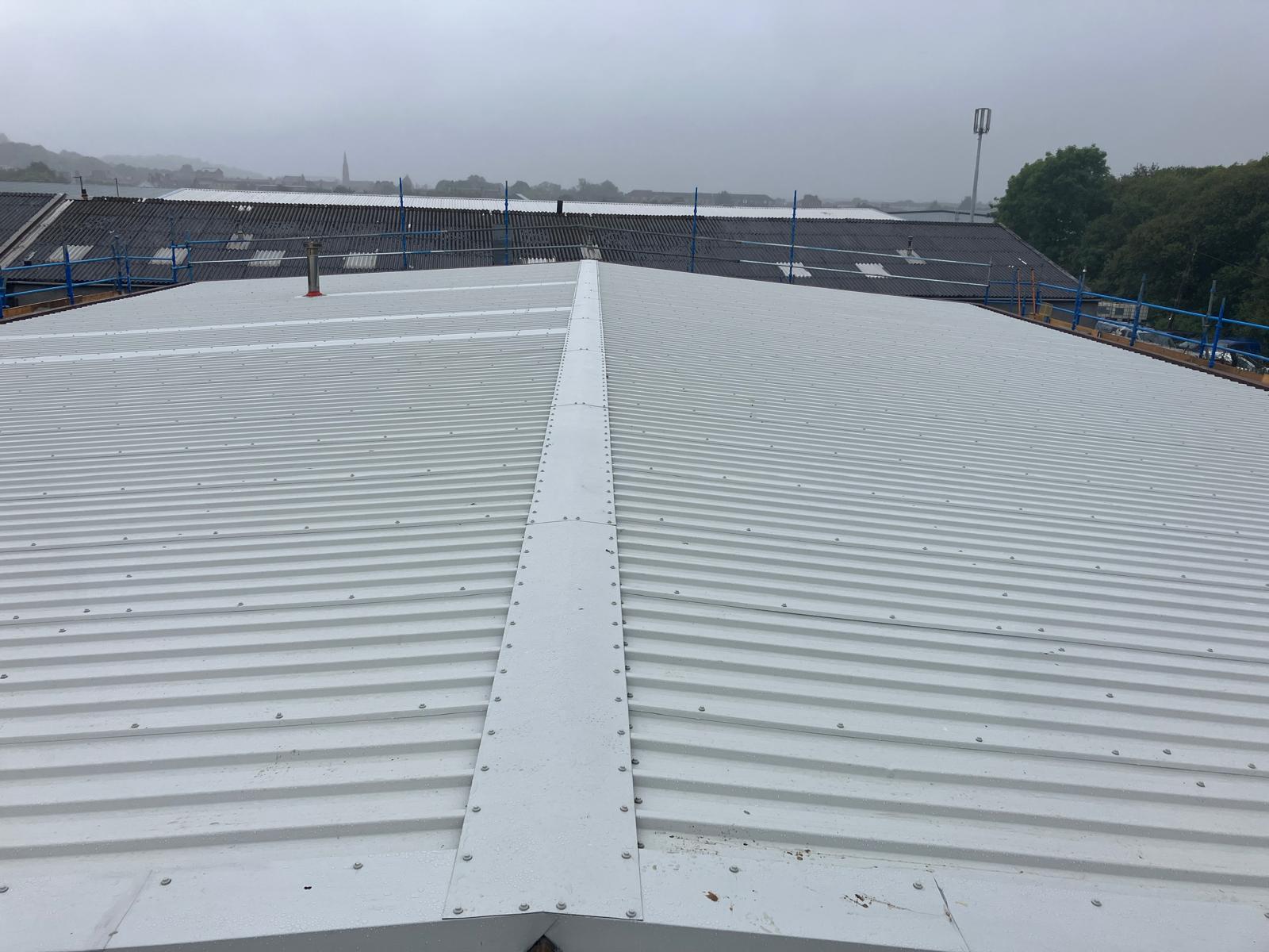Completed AS30/1000 single skin roof overlay with new ridge flashing at an industrial building on Wallneuk Road, Paisley
