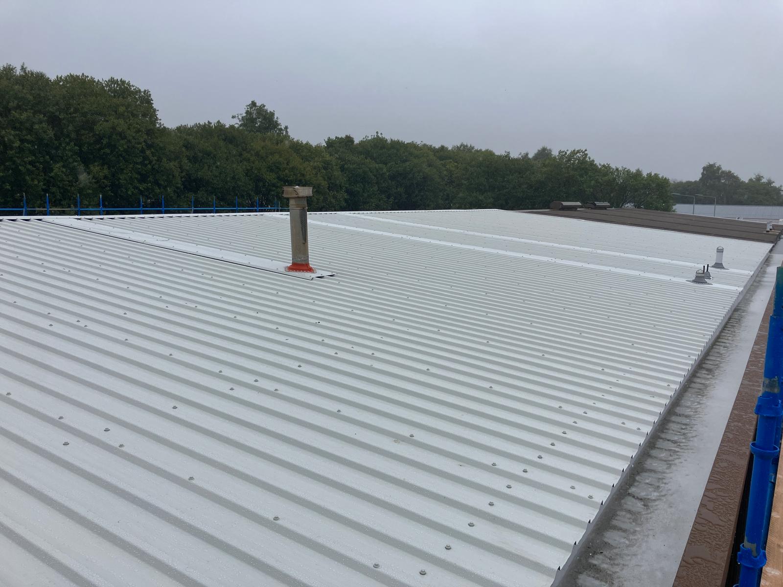 New AS30/1000 roof sheeting and verge flashing installed during industrial roof overlay works at Wallneuk Road, Paisley