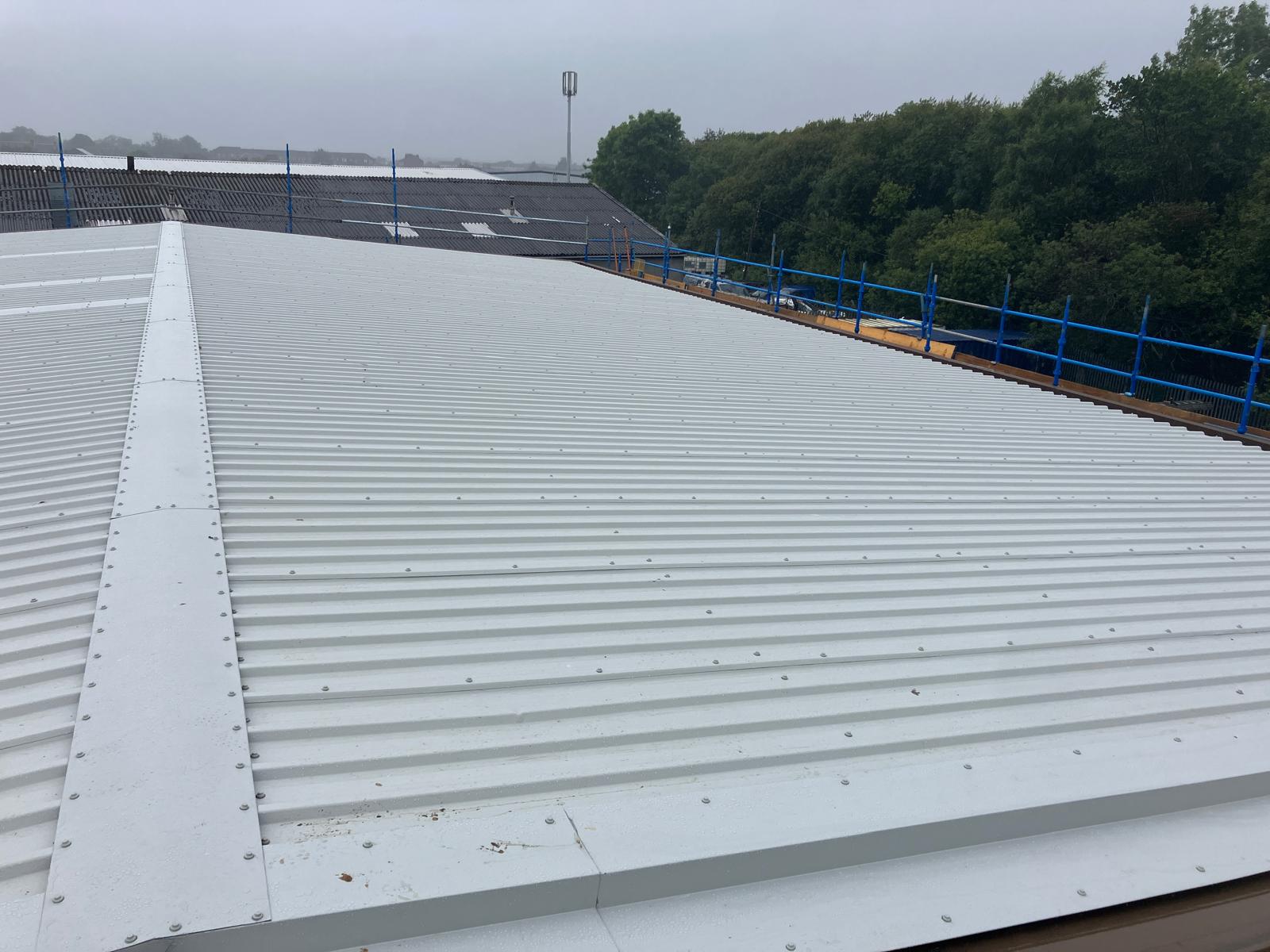 Completed verge flashing detail on new roof overlay system at an industrial building on Wallneuk Road, Paisley