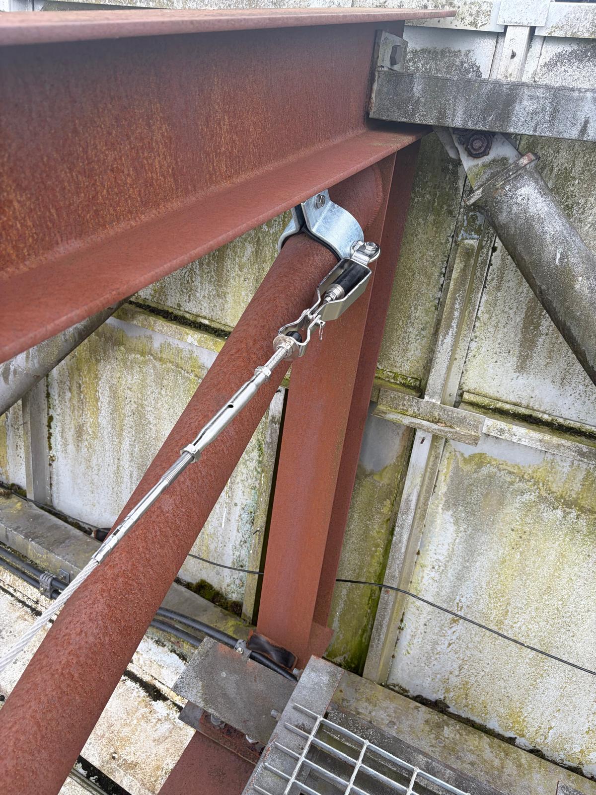 Close detail of a horizontal lifeline anchorage bracket installed on the roof steelwork at Hampden Park as part of the new fall protection system