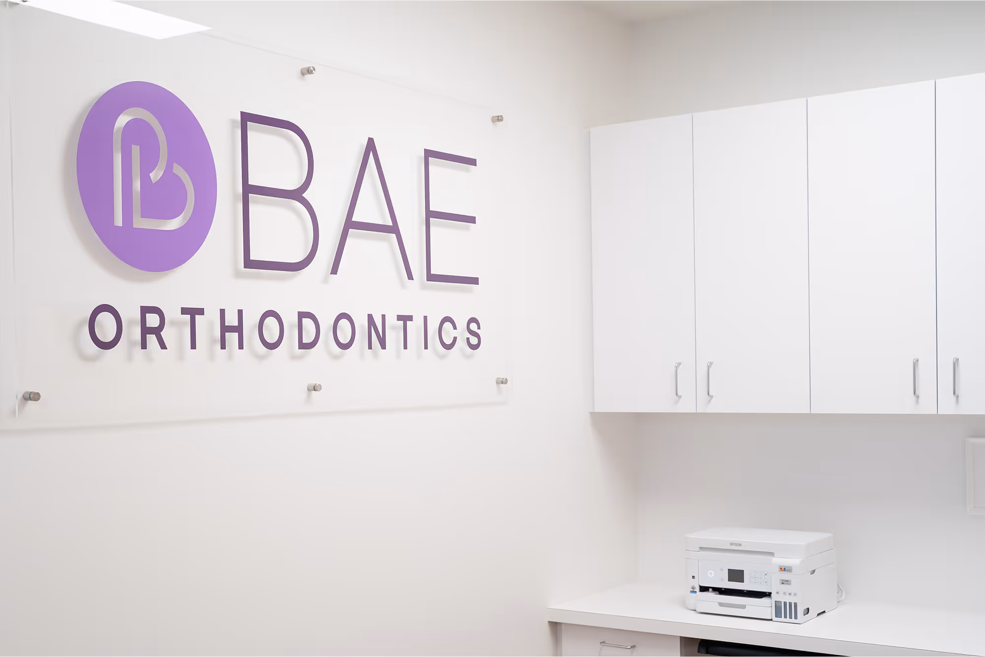 A white room with a sign that says bae orthodontics.