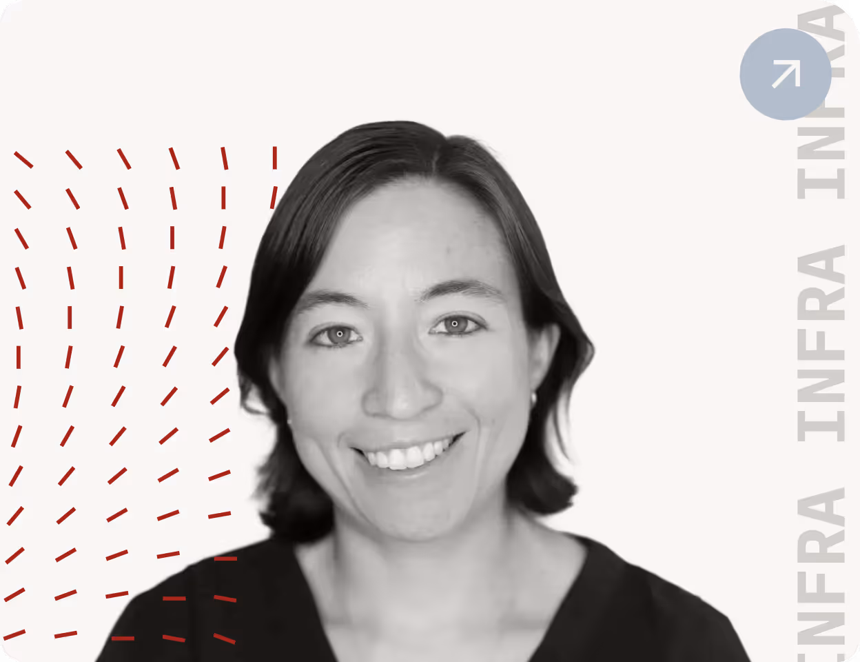 Black and white headshot of a smiling woman with short dark hair wearing a dark top, with red line patterns on the left side.