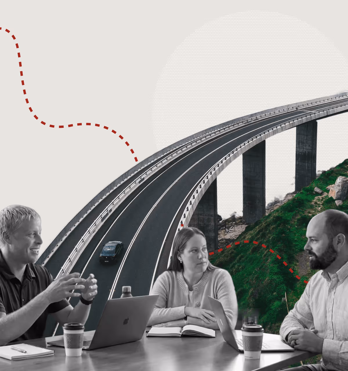 Three professionals sitting at a table with laptops and notebooks, engaged in discussion, with a curved highway bridge and green hill in the background.