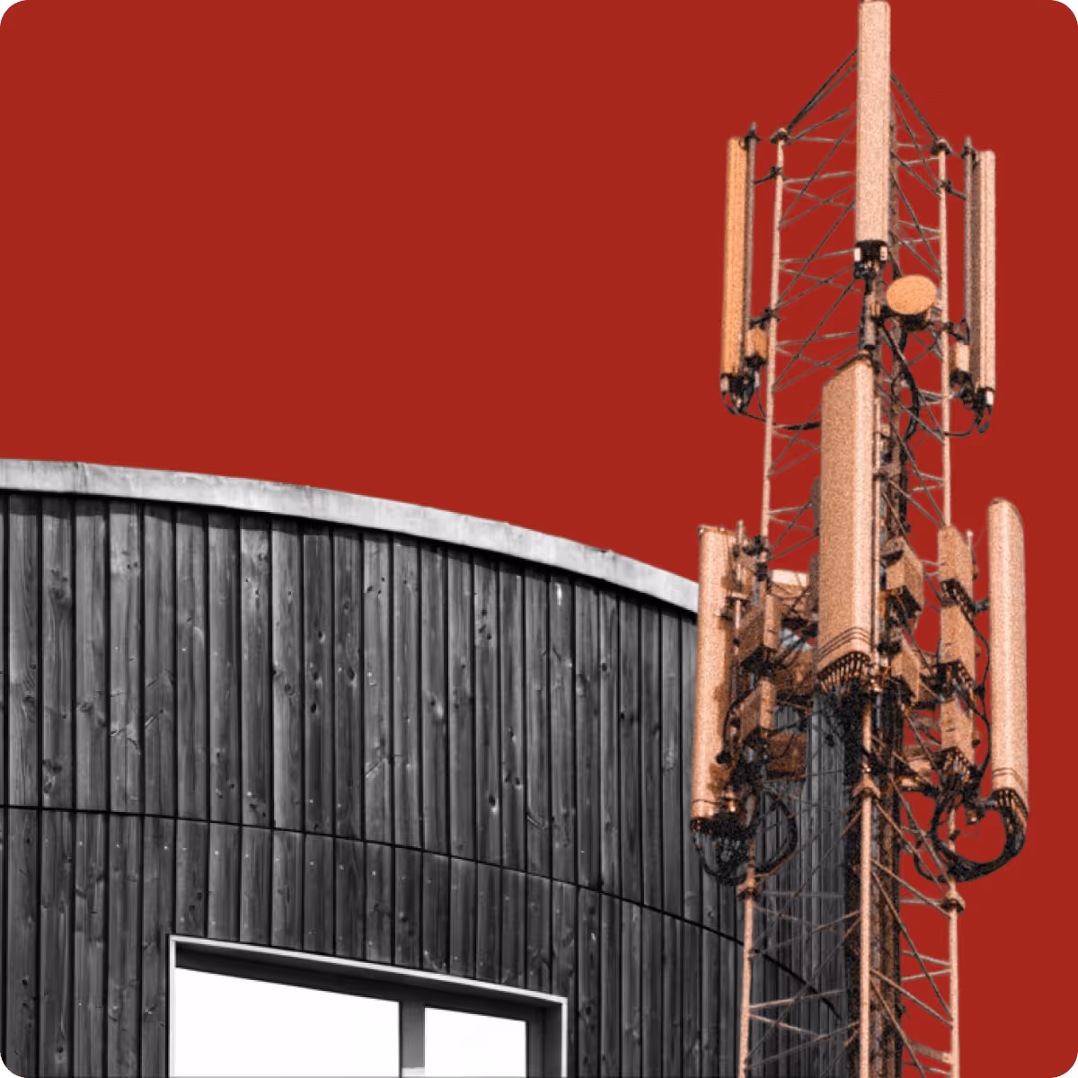 Telecommunication antenna tower beside a curved wooden building facade with a window, set against a solid red background.